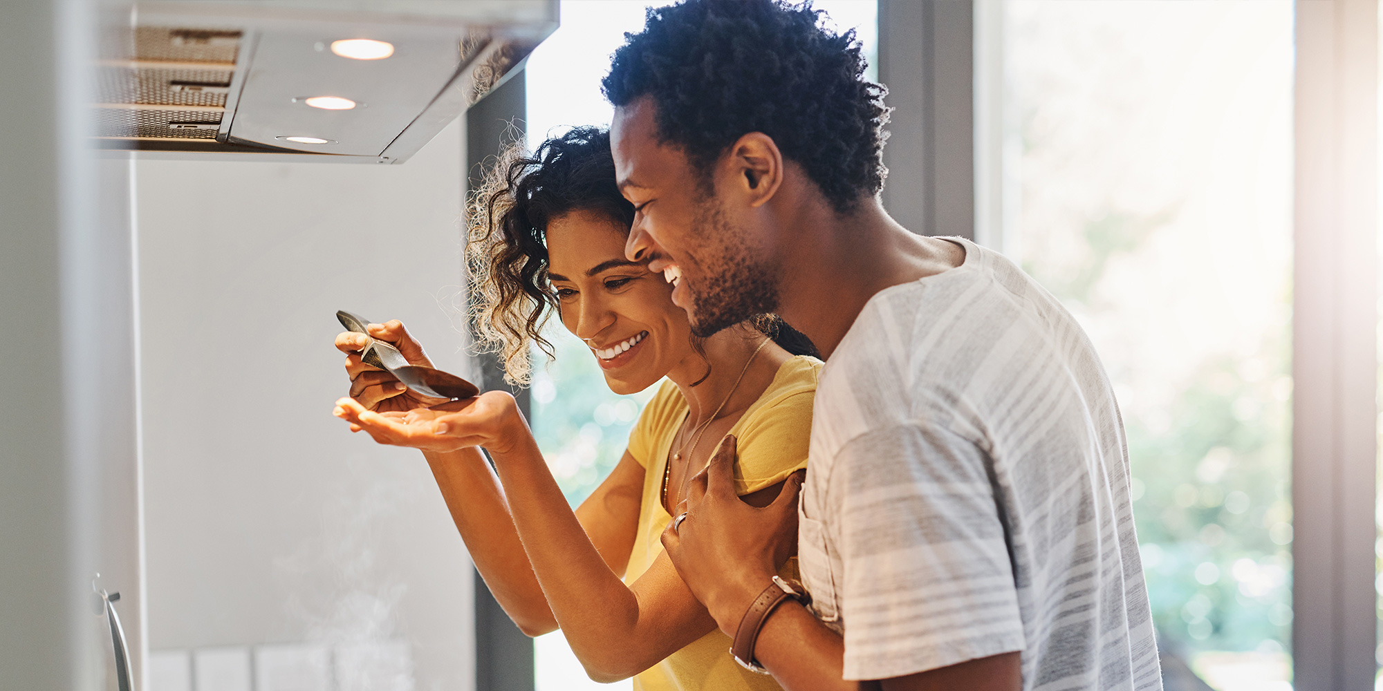 Smiling African-American couple cooking together